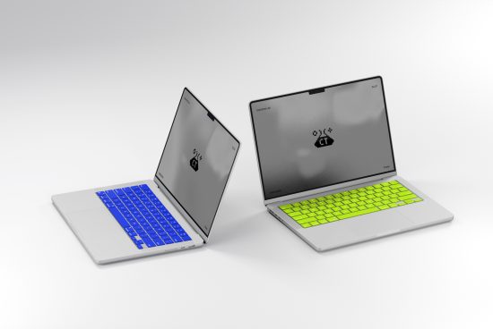 Two modern laptops with vibrant blue and green keyboards open and facing each other in a minimalist white setup, ideal for mockups and design presentations.